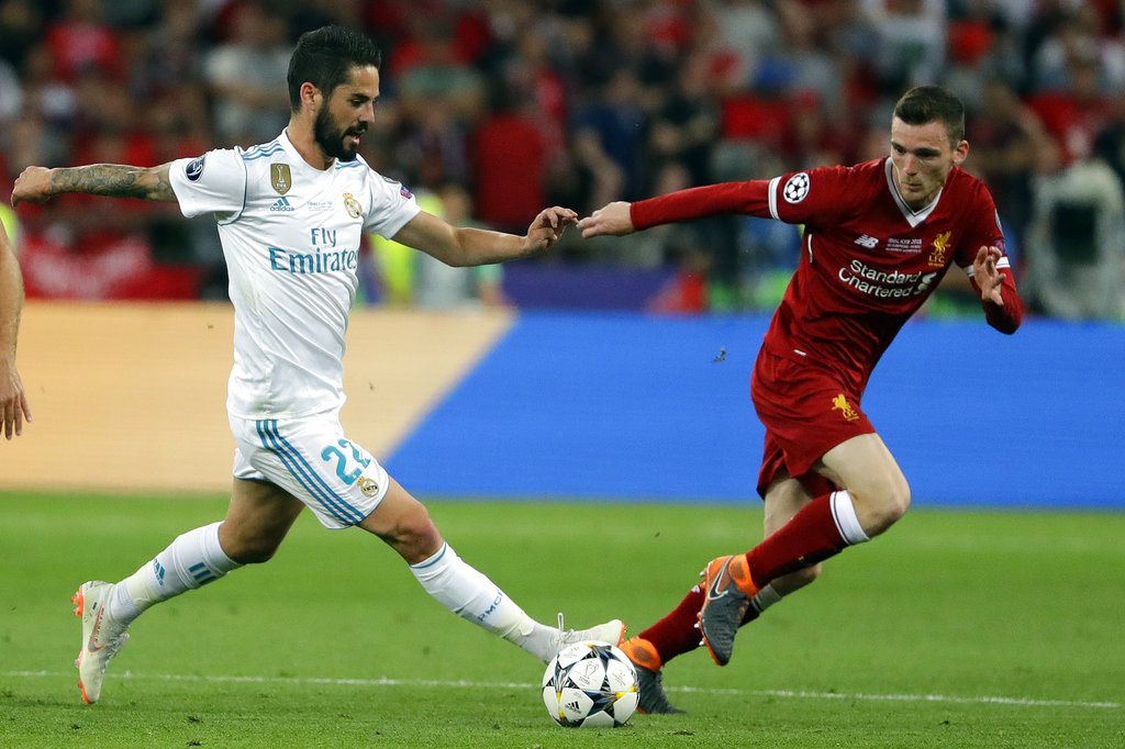 Real Madrid's Isco, left, and Liverpool's Andy Robertson challenge